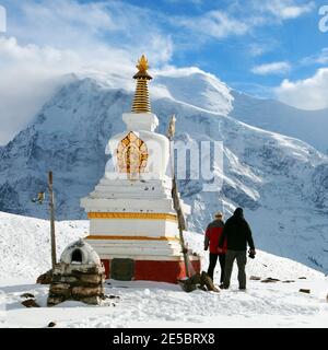 Sehen Sie buddhistische Stupa, zwei Touristen, Annapurna 2 II und 3 III, Weg zu Thorung La Pass, rund Annapurna Circuit Trekking Trail, Nepal Stockfoto