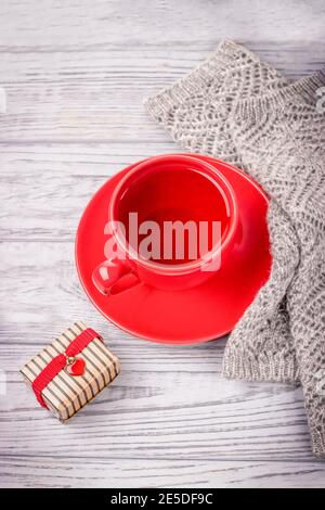 Rote Tasse Tee und ein Geschenk zum Valentinstag Mit rotem Herzen Stockfoto