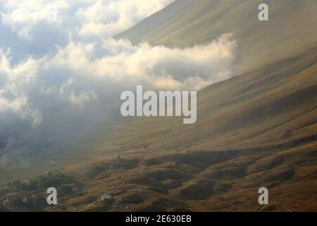 Nebel kriecht auf Häusern und Reittieren im Nordlibanon. Stockfoto