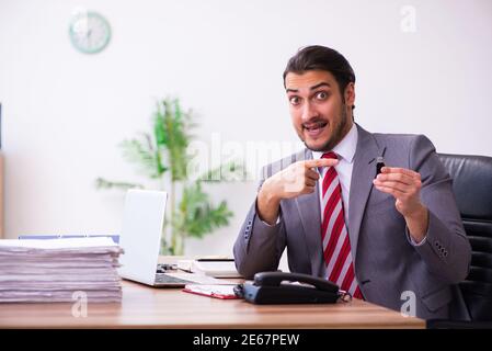 Männlicher Mitarbeiter, der Flash-Laufwerk in den Laptop einsteckt Stockfoto