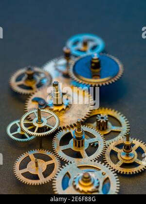 Hintergrund für Kupferzahnräder. Gealterte mechanische Uhrräder aus der Nähe. Geringe Schärfentiefe. Stockfoto