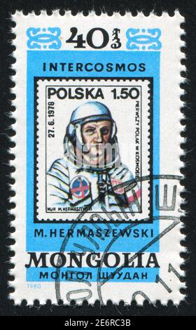 MONGOLEI - UM 1980: Briefmarke gedruckt von Mongolei, zeigt Astronaut, um 1980 Stockfoto