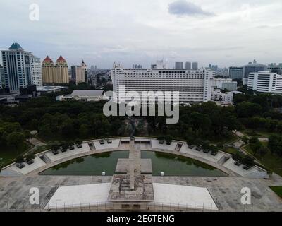 Luftaufnahme des West Irian Liberation Monument in der Innenstadt von Jakarta und Lärmwolke mit Jakarta Stadtbild. JAKARTA - Indonesien. Januar 30, 2021 Stockfoto