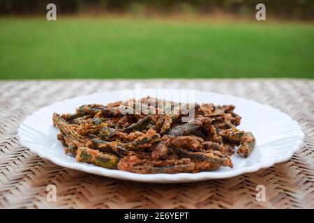 Indisches Curry oder Vorspeise Vorspeise Bhindi braten oder kurkurkurure bhindi Auch bekannt als Dame Finger tief braten.traditionelle und authentische indische Cuisine Okra Fry Ser Stockfoto