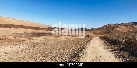 panorama of the Makhtesh ramon crater in israel showing north and south rims, mount arod, and volcanic formations with a clear sky background Stockfoto