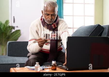 Kranker alter Mann versucht, Medikamente online in Laptop zu kaufen, indem er Drogendetails eingibt - Konzept der Pharmazie, E-Commerce und Online-Kauf Stockfoto