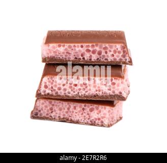 Poröse Schokoladenstücke isoliert auf weißem Hintergrund. Rosa Erdbeere belüftene Schokolade. Stockfoto