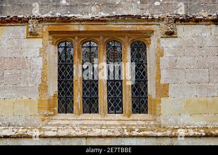 Ein altes Bleifenster mit einem Betonrahmen in einem Altes englisches Landhaus Stockfoto