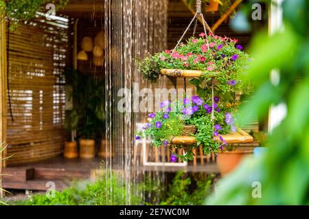 Hängende Blumendekoration und Vorhang Wasserfall im schönen Garten Stockfoto