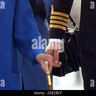 DER KOMMANDIERENDE OFFIZIER DER HMS ARK ROYAL HÄLT DIE HAND DER KÖNIGIN, WÄHREND SIE IHREN BUGGY IGNORIERT, UM AUF DAS FLUGDECK DER HMS ARK ROYAL ZU GEHEN. 2001 Stockfoto