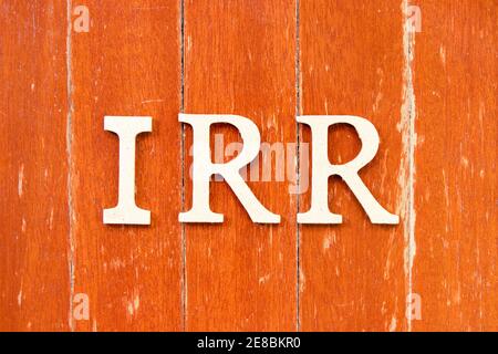 Alphabet letter in word IRR (Abbreviation of internal rate of return) on old red color wood plate background Stockfoto
