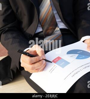 Businessman wertet Unternehmensdaten aus und prüft Diagramme und Werte Stockfoto