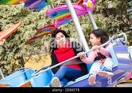 Mutter und Tochter Spaß und lächelnd in einem Freizeitpark Spiel Stockfoto