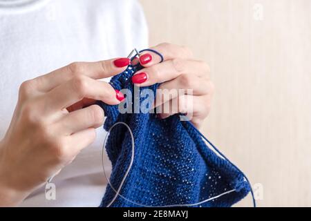 Nahaufnahme von weiblichen Händen Stricken einen blauen Schal. Stockfoto