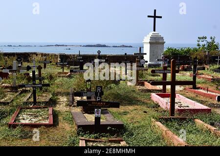 Kerala, Indien - Januar, 2017: Alter historischer katholischer Friedhof. Gräber mit Kreuz an der Küste hinter der Kolonialkirche nahe Thalassery Fort Stockfoto