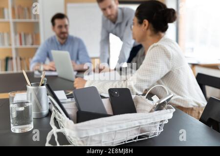 Schließen des Korbes mit Smartphones bei Firmenmeeting verboten Stockfoto