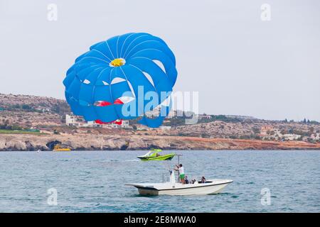 Ayia Napa, Zypern - 16. Juni 2018: Parasailing Boot mit Touristen in Agia Napa Bucht Stockfoto