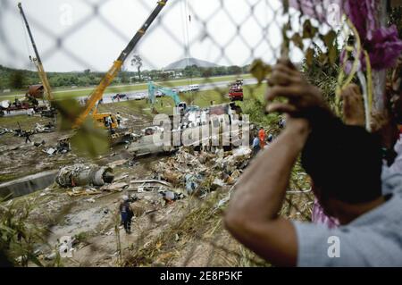 Rettungskräfte begutachten am 17. September 2007 den Flugzeugabsturz auf dem Flughafen von Phuket in Thailand.EIN Billigflugzeug mit 128 Personen an Bord stürzte am 16. September 2007 auf der thailändischen Ferieninsel Phuket ab. 88 Menschen wurden getötet, als es aufbrach und in Flammen aufging, während er versuchte, bei starkem Regen zu landen.die restlichen 42 Menschen an Bord des Fluges aus Bangkok überlebten und wurden in nahe gelegenen Krankenhäusern wegen einer Vielzahl von Verletzungen behandelt. Foto von Patrick Durand/ABACAPRESS.COM Stockfoto
