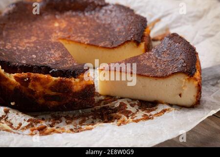 Traditioneller baskischer gebrannter Käsekuchen auf dem Backpapier Stockfoto