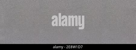 Grauer grober körniger Putz mit vielen kleinen Steinen Stockfoto