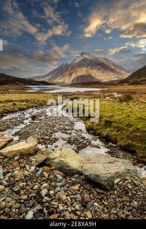 Trittsteine über den Bach, der zum Lake Idwal im Cwm Idwal Nature Reserve führt, mit Pen yr Ole Wen Berg im Hintergrund, Snowdonia, Wales Stockfoto