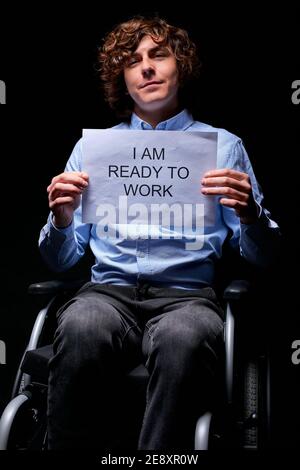 Junge ungültige Mann nicht aufgeben trotz Behinderung, auf der Suche nach Arbeit, bereit, wie jeder arbeiten, isoliert auf schwarzem Hintergrund Stockfoto