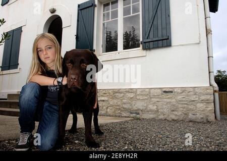 Clara Bellocq, 12 ans, pose avec Yago son labrador, sur le perron de sa maison le 5 octobre 2007, a Biarritz, Frankreich. Son autre chien Pirate, un caniche Bichon, fait Partie des huit chiens morts empoisonnes entre le 22 et le 30 septembre 2007 dans le quartier du Golf de Biarritz. Yago le labrador a du subir un lavage d'estomac apres avoir ingurgite une tacisse suspecte. Eine Frage an eine äte ouverte. Jules Motte/ABACAPRESS.COM Stockfoto