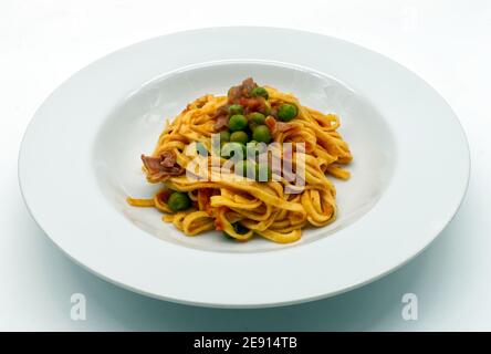 Frische italienische Tagliatelle mit Schinken und Erbsen Sauce. Traditionelle italienische Pasta. Stockfoto