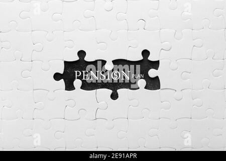 Unvollständiges Puzzle mit Text PENSIONSPLAN auf dunklem Hintergrund Stockfoto