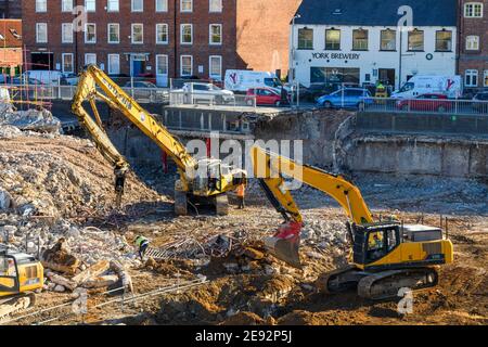 Demolition site High view (Schutt Haufen, schwere Maschinen, Bagger, Menschen arbeiten) - Hudson House, York, England, Großbritannien. Stockfoto