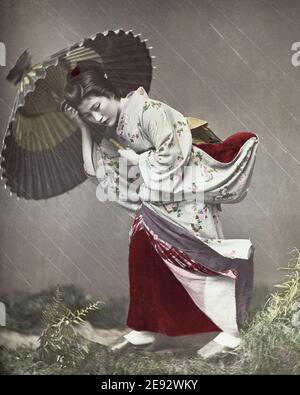 Foto aus dem späten 19. Jahrhundert - 'Girl in a Storm' Japan, Geisha mit Regenschirm, Kusakabe Kimbei Studio. Stockfoto