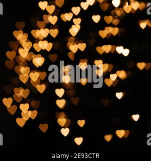 Gold Hintergrund Bokeh Lichter Herz, valentine Hintergründe, verschwommen funkeln für Nacht Hintergrund. Unschärfe-Thema der Liebe Banner. Liebevolle, positive Emotio Stockfoto