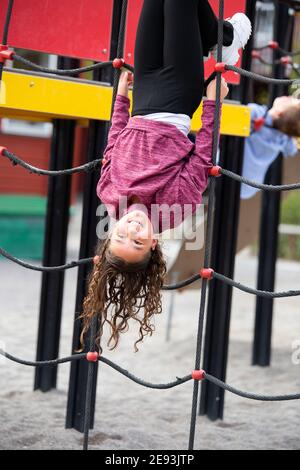 Mädchen spielen auf Klettergerüst Stockfoto