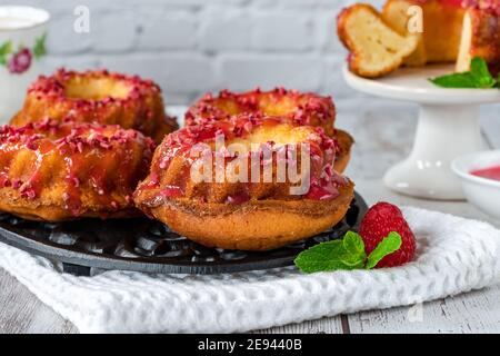 Mini Vanille Pfund Kuchen mit Himbeer-Vereisung Stockfoto