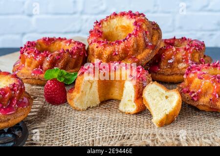 Mini Vanille Pfund Kuchen mit Himbeer-Vereisung Stockfoto