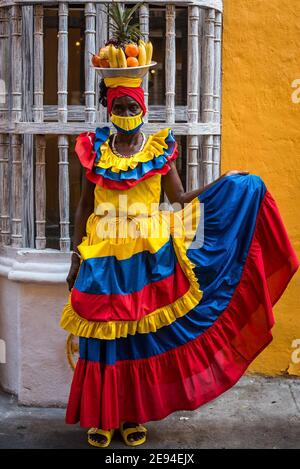 Cartagena, Kolumbien Februar 2021: Frauen Obsthändler Obstverkäufer Frau namens Palenquera trägt Gesichtsmaske während der Pandemie COVID 19 Reise Stockfoto