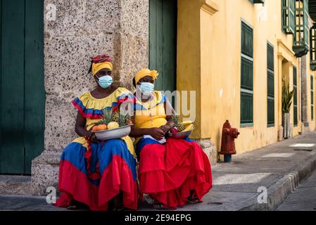 Cartagena, Kolumbien Februar 2021: Frauen Obsthändler Obstverkäufer Frau namens Palenquera trägt Gesichtsmaske während der Pandemie COVID 19 Reise Stockfoto