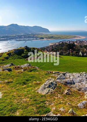 View looking down over Deganwy and the mouth of the River Conwy in Conwy North Wales from the ruins of Deganwy Castle with rocks in foreground. Stockfoto