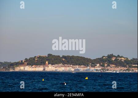 Blaues Wasser des Golfs von Saint-Tropez mit Umrissen der Stadt Saint-Tropez im Hintergrund, Französische Riviera, Frankreich im Sommer Stockfoto