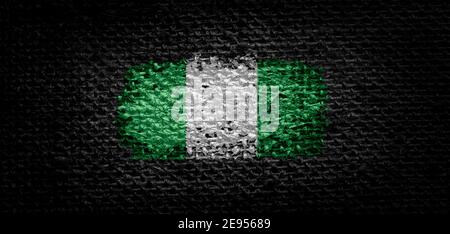 Nationalflagge der Nigeria auf dunklem Stoff Stockfoto