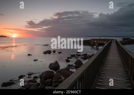 Sonnenuntergang an Pfannen Felsen in der Nähe von Ballycastle, County Antrim, Nordirland Stockfoto