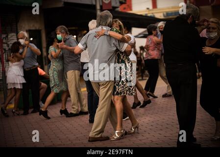 Castelar, Argentinien. Januar 2021, 24th. Menschen unterschiedlichen Alters tanzen Tango mit Masken inmitten der Corona-Pandemie in einer Fußgängerzone am Rande der Hauptstadt. "Wir tun dies aus Liebe zum Tango. Wir wollen kein Geld dafür", sagt der Organisator dieser Abende, Malaver, der seinen Lebensunterhalt damit verdient, Haarverlängerungen zu verkaufen. Trotz der Pandemie versammeln sich am Sonntag viele Menschen, um den Tango zu tanzen. Quelle: Alejo Manuel Avila/dpa/Alamy Live News Stockfoto