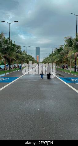 Eine Frau, die mit einem Kind auf der Straße in Corniche, Jeddah, Saudi-Arabien, 2021 Stockfoto