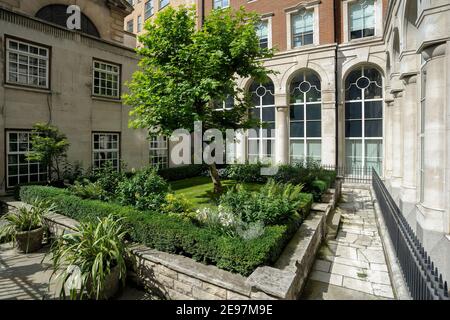 LONDON, Großbritannien - 15. AUGUST 2009: Hübscher Kirchgarten von St. Edmund, König und Märtyrer Kirche von George Yard aus gesehen Stockfoto