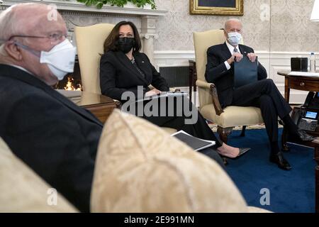 Präsident Joe Biden, rechts, trägt eine Schutzmaske beim Treffen mit US-Vizepräsident Kamala Harris, Mitte, und demokratischen Senatoren, um den amerikanischen Rettungsplan im Oval Office des Weißen Hauses in Washington am Mittwoch, 3. Februar 2021 zu diskutieren. (Stefani Reynolds/The New York Times) Stockfoto