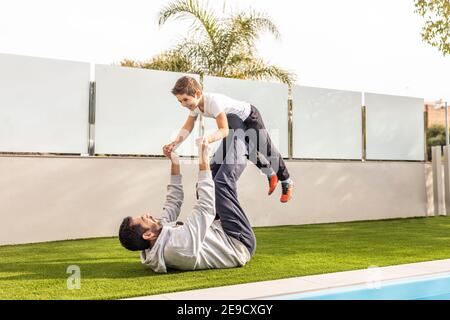 Vater und Sohn machen Übung in ihrem Garten. Fokus in der Hand. Stockfoto