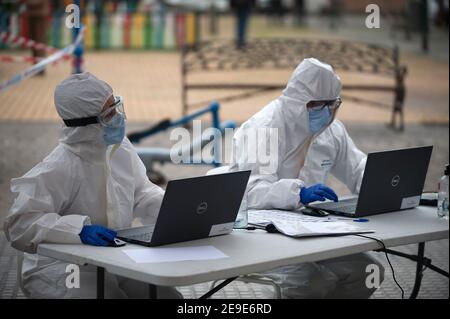 Malaga, Spanien. Februar 2021, 04th. Gesundheitshelfer, die einen Anzug für persönliche Schutzausrüstung (PSA) tragen, sitzen mit ihren PCs während einer massiven covid-19-Prüfung am Plaza Limeno in der Innenstadt. Aufgrund der hohen Rate von Coronavirus-Infektionen in der Hauptstadt Málaga werden etwa 1,600 freiwillige Personen von den Gesundheitsbehörden ausgewählt, um an einem zufälligen Antigencovid-19-Test teilzunehmen. Kredit: SOPA Images Limited/Alamy Live Nachrichten Stockfoto