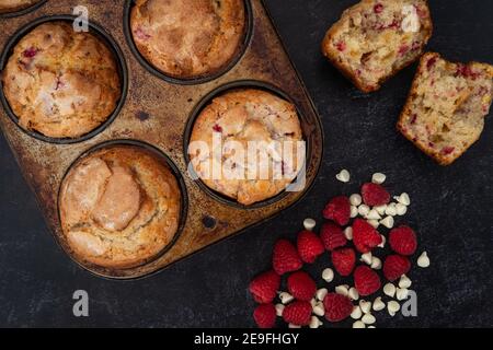 Frisch gebackene Himbeer weiße Schokolade Muffins Kühlen auf der Theke Stockfoto