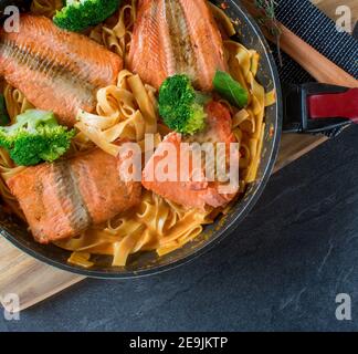 italienisches Fischgericht mit gebratenem Lachs, Pasta und Sahne-Sauce von oben mit Kopierplatz Stockfoto