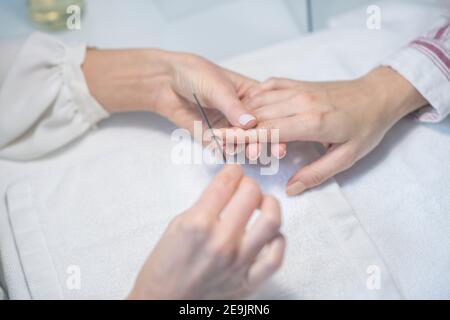 Nahaufnahme von Nagelkünstler Hände tun Maniküre Stockfoto